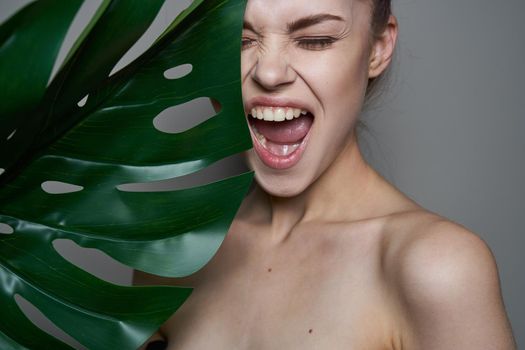 pretty woman palm leaf bare shoulders clear skin spa treatments. High quality photo