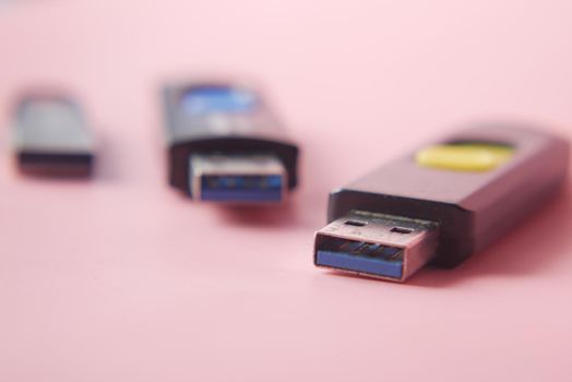 USB flash drive on blue background close up .