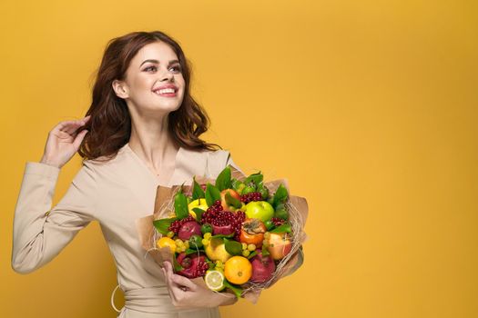 portrait of a woman fun posing fruit bouquet vitamins colorful background. High quality photo