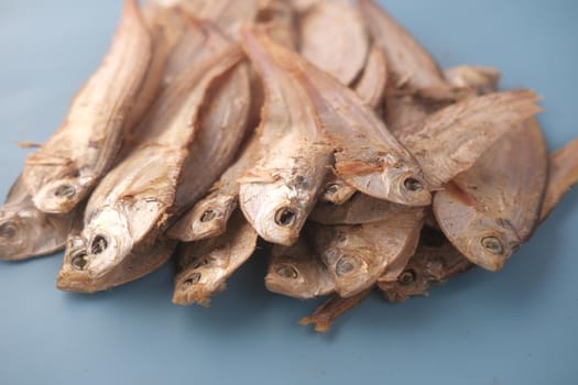 close up of dried fish on blue backgrund .