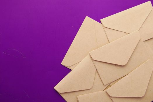 envelope on p on purple background on top view .