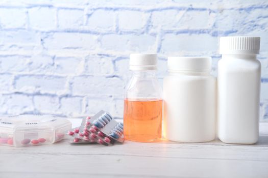 many medical pill container on table .