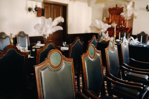 Antique chairs for a wedding evening in the restaurant of an old castle.