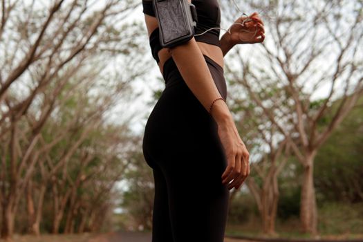 beautiful woman listening to music in the park