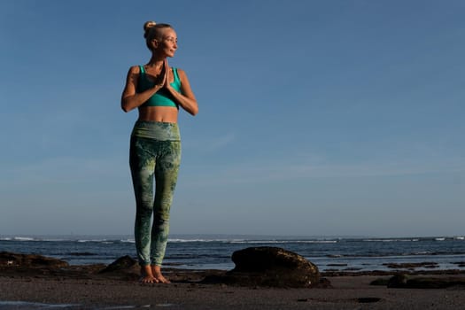 beautiful woman doing yoga on the beach. Bali