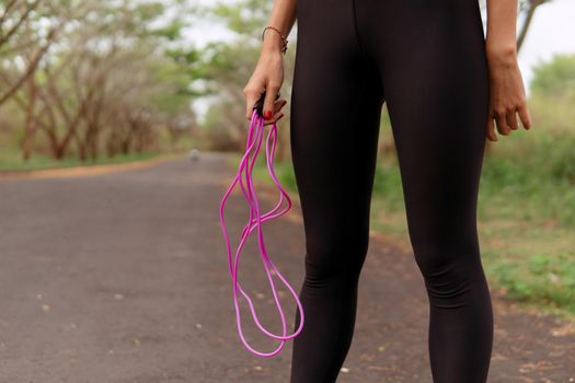 close up woman jumping pink rope. bali