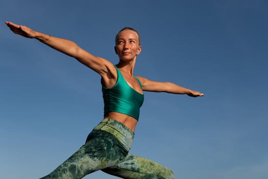 beautiful woman doing yoga. middle plan. bali