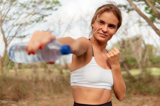 woman warm up with bottle of water. bali