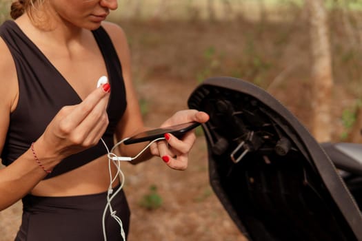 beautiful woman listening to music in the park