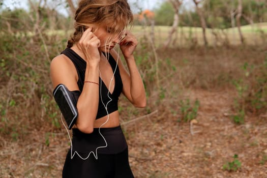 beautiful woman listening to music in the park