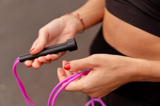 close up woman jumping pink rope. bali