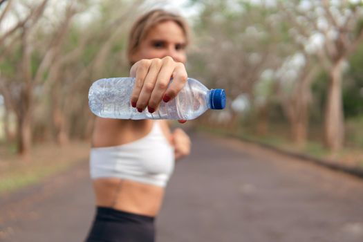 woman warm up with bottle of water. bali