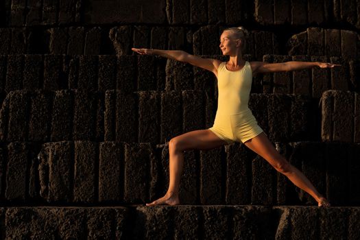 beautiful woman in yellow doing yoga. bali