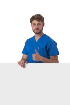 Healthcare, profession and medicine concept - happy smiling male doctor or nurse in blue uniform with big board showing thumbs up isolated over white background