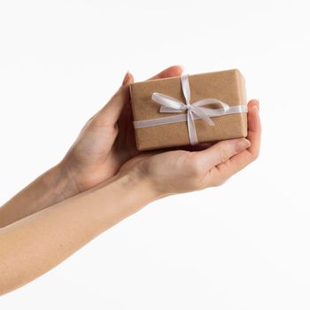hands holding gift with bow. High resolution photo