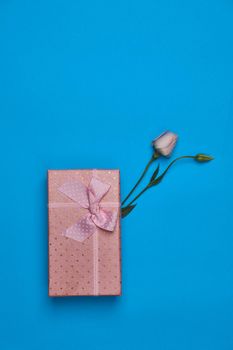 gift box flowers celebration birthday blue background. High quality photo