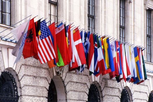 The flags of many nations on a building