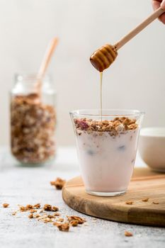 front view yogurt with granola honey. High resolution photo
