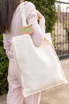 woman holding reusable bag with eco sign. High resolution photo