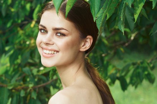 portrait of a woman Cosmetology nature green leaves glamor cropped view. High quality photo