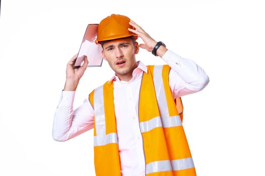 working man in orange uniform posing construction. High quality photo