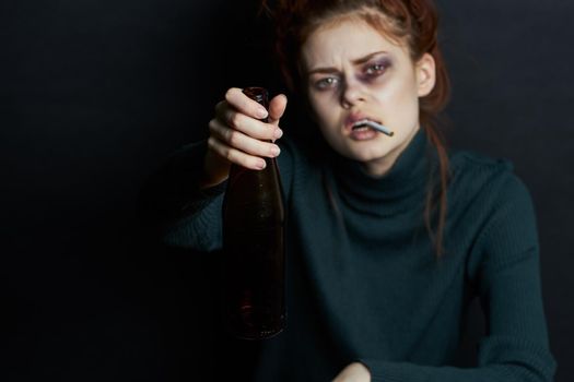 woman with bottle of alcohol smokes a cigarette depression bruises under eyes emotions. High quality photo