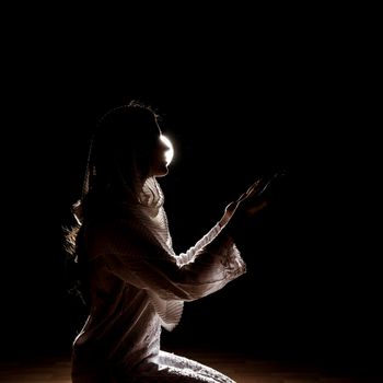 silhouette muslim woman praying. High resolution photo