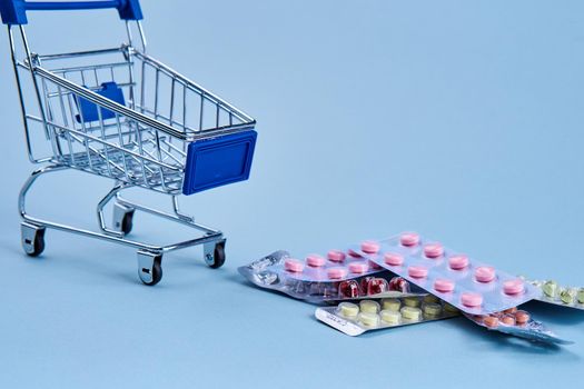 packs of pills in a trolley shopping in a pharmacy medicines. High quality photo