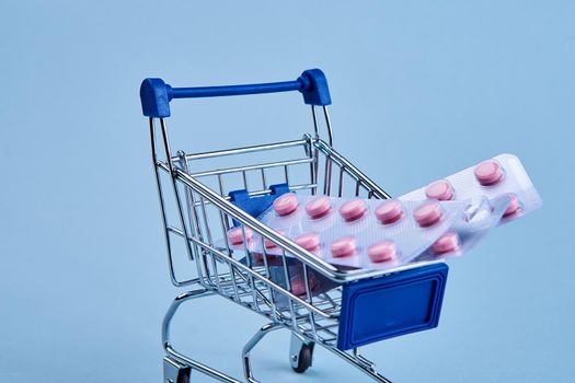 packs of pills in a trolley shopping in a pharmacy medicines. High quality photo