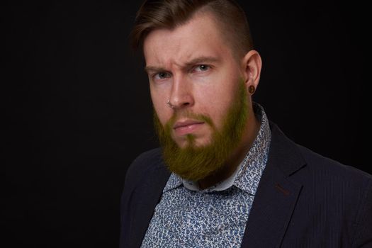 fashionable business man in a jacket with a beard posing. High quality photo