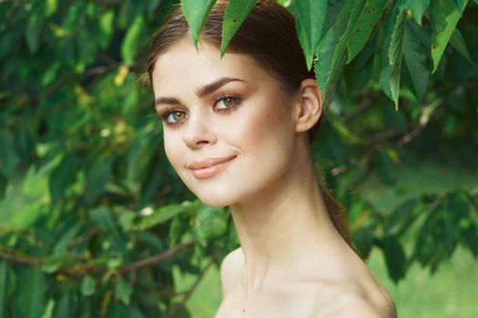 beautiful woman skin care bare shoulders green leaves nature Lifestyle. High quality photo