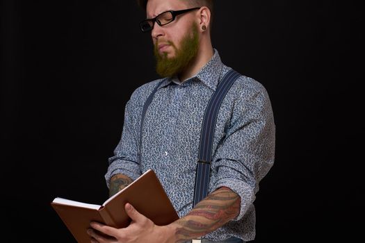 a business man in a shirt with a notebook in the hands of a manager. High quality photo