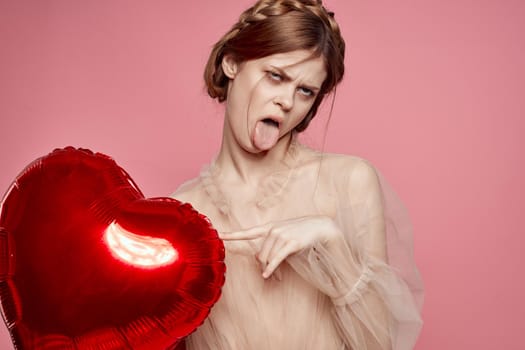 portrait of a woman red heart in the hands of the balloon isolated background. High quality photo