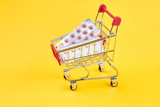 drug trolleys service delivery shopping pharmacy yellow background. High quality photo