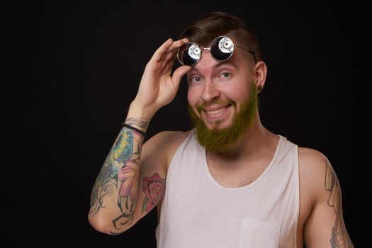 cheerful bearded man in white t-shirt sunglasses posing. High quality photo