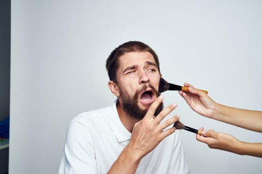 bearded man in white shirt cosmetics makeup. High quality photo