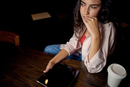 cheerful woman sitting in a cafe in front of a laptop communication internet lifestyle. High quality photo