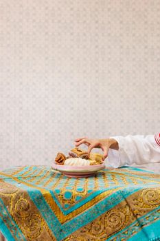 hand taking piece arab pastry. High resolution photo