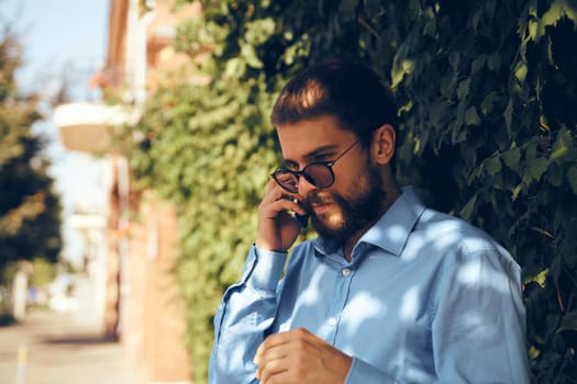 male manager with a phone in his hands on the street communication. High quality photo