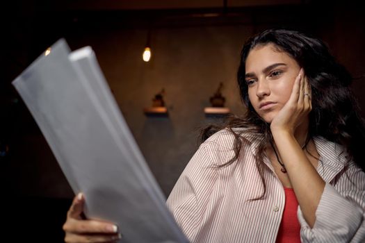 woman in a cafe at a table in front of a laptop device communication. High quality photo