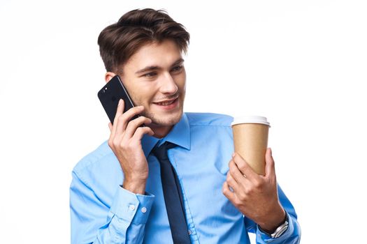 manager communication on the phone a cup of coffee light background. High quality photo