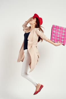 pretty woman wearing a red hat posing shopping fun studio model. High quality photo