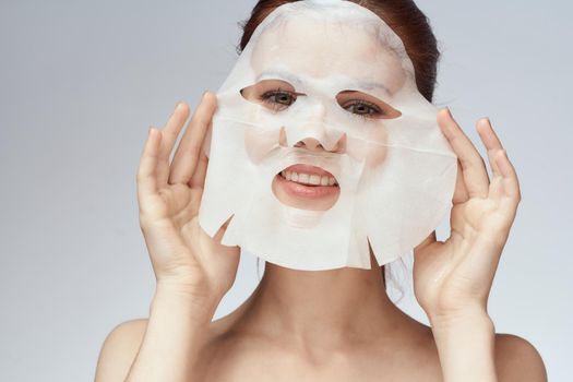 woman with bare shoulders face mask skin care procedures. High quality photo