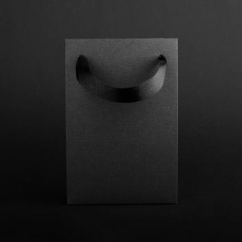 Black Friday blank empty paper bag with copy space for text and logo on dark background sale concept