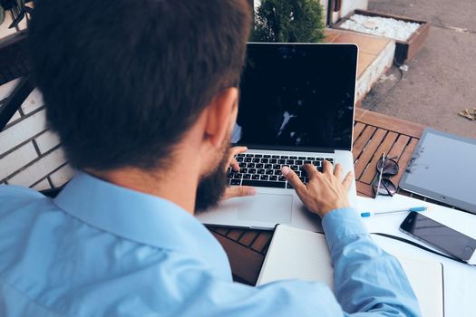 manager working in cafe with laptop outdoors. High quality photo