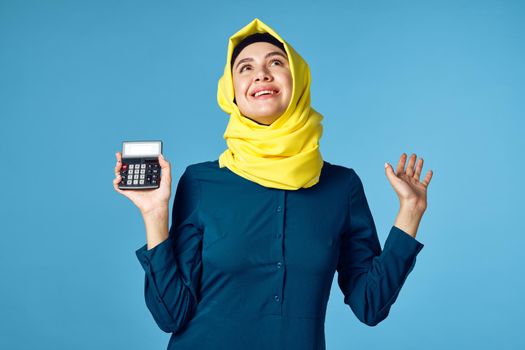 woman in yellow hijab technology calculator work finance. High quality photo