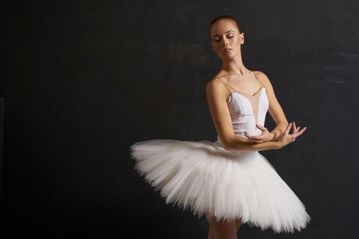 ballerina in a white tutu dance performance silhouette dark background. High quality photo