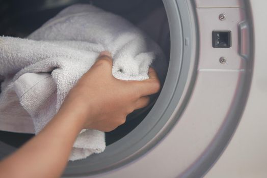 putting towel and cloths in a washing machine