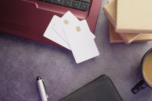 high angle view of credit cards on laptop on table .