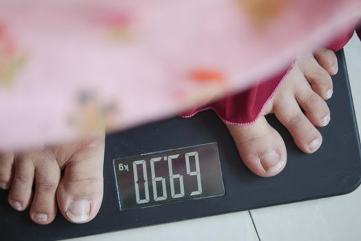 woman's feet on weight scale close up